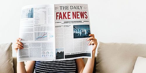 Woman reading newspaper
